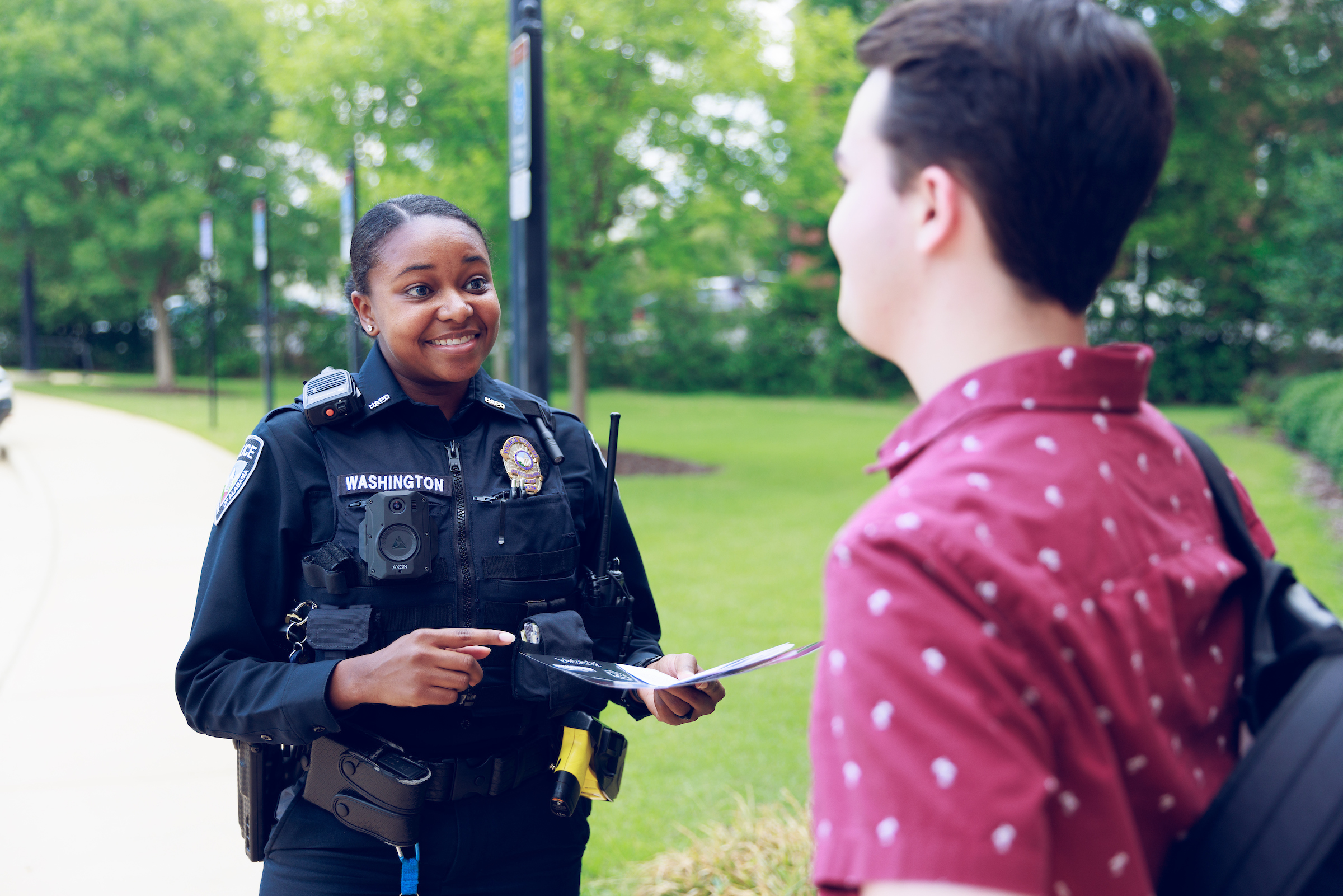 Photo of UAPD officer speaking with student